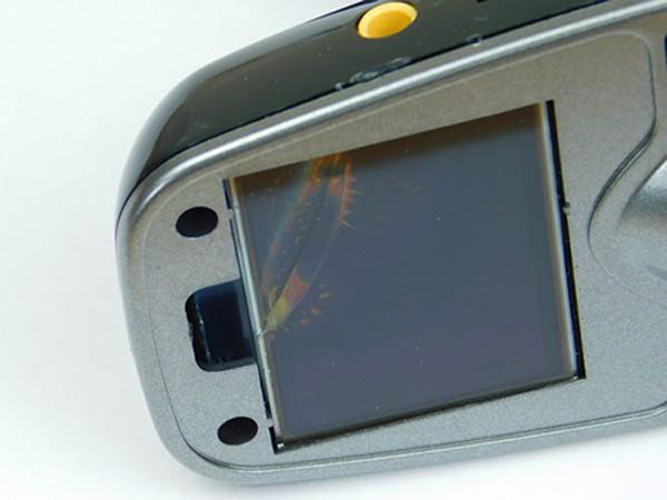 The two screw holes and the cracked screen.